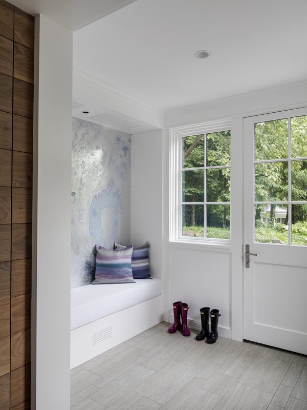 mudroom with large cushioned bench© Jacob Lilley Architects Wellesley, MA
